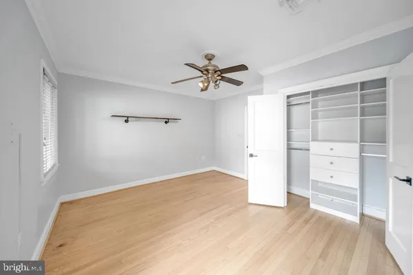 an empty room with cabinet and a ceiling fan