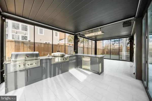 a large white kitchen with a large window