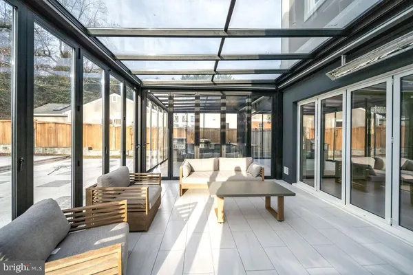 a living room with furniture and a large window with outer view