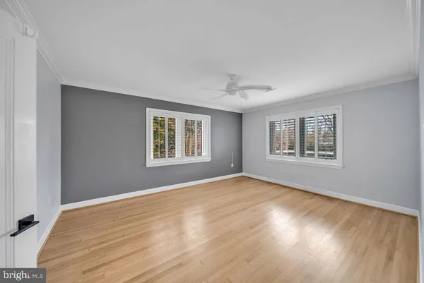 a view of empty room with wooden floor and window