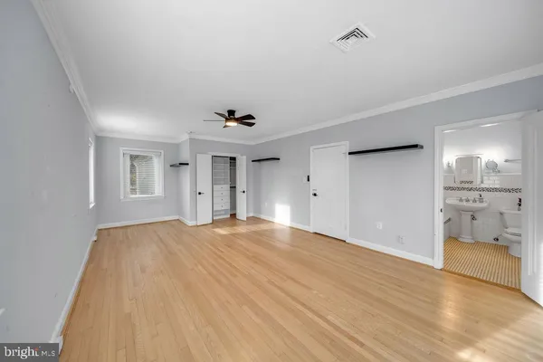 a bathroom with a sink a toilet a mirror and shower