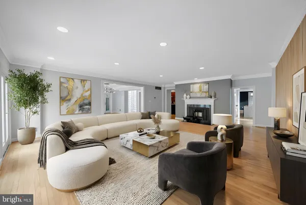 a living room with furniture fireplace and a large window