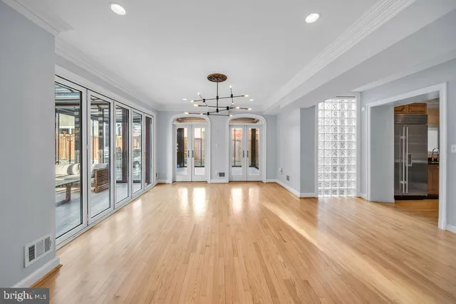 an empty room with cabinet and a ceiling fan