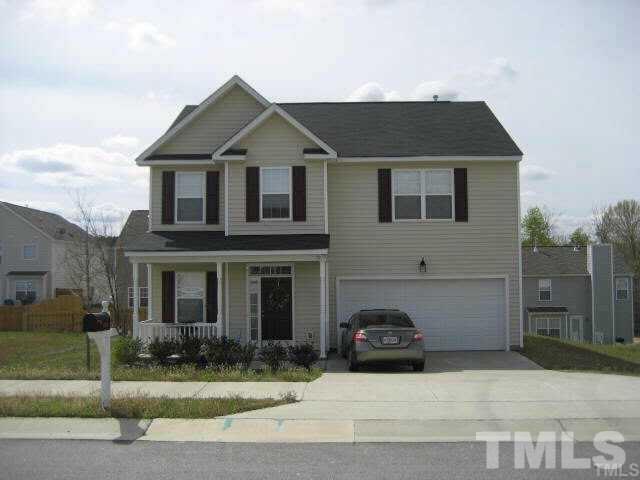 4305 Bay Rum Lane Raleigh, NC 27610 - Photo 1 of 17 a front view of a house with a yard