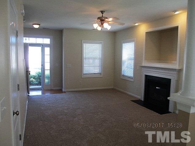 4305 Bay Rum Lane Raleigh, NC 27610 - Photo 2 of 17 a view of a livingroom with a fireplace cabinet and windows