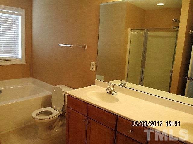 4305 Bay Rum Lane Raleigh, NC 27610 - Photo 13 of 17 a bathroom with a sink a toilet and tub