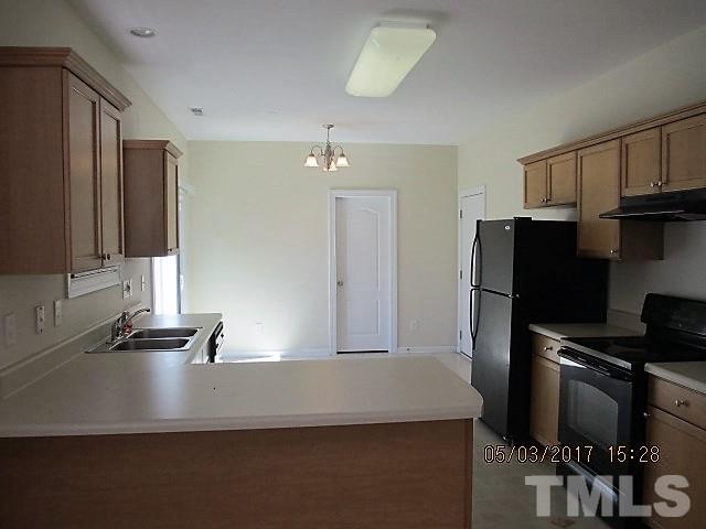 4305 Bay Rum Lane Raleigh, NC 27610 - Photo 5 of 17 a kitchen with kitchen island a counter top space cabinets and stainless steel appliances