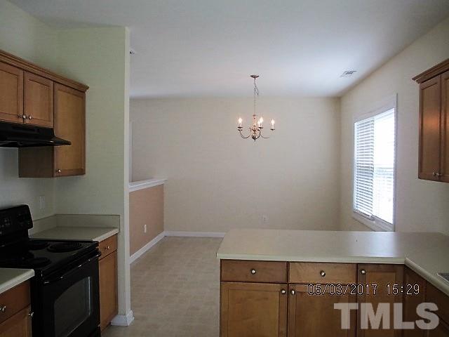 4305 Bay Rum Lane Raleigh, NC 27610 - Photo 6 of 17 a view of kitchen with a sink cabinets and a stove top oven