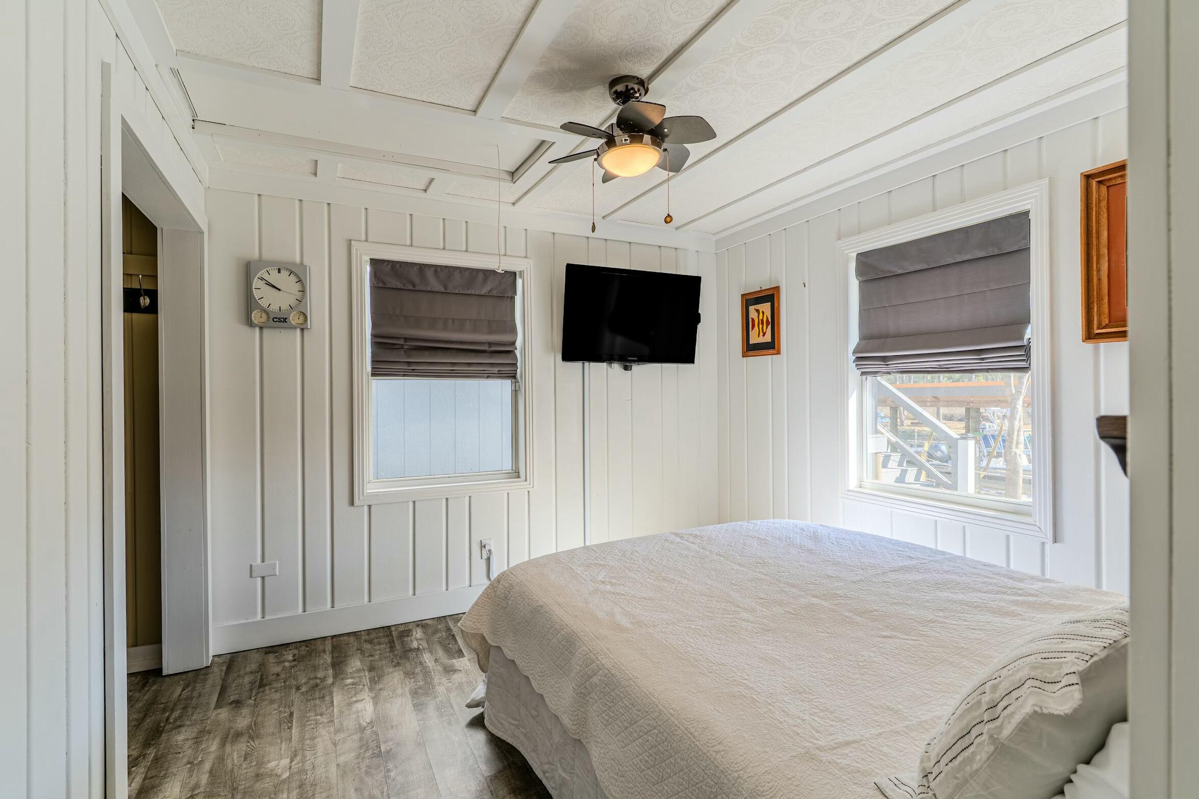 175 Ruth Road Freeport, FL 32439 - Photo 15 of 69 a bedroom with a large bed a flat tv screen and a window