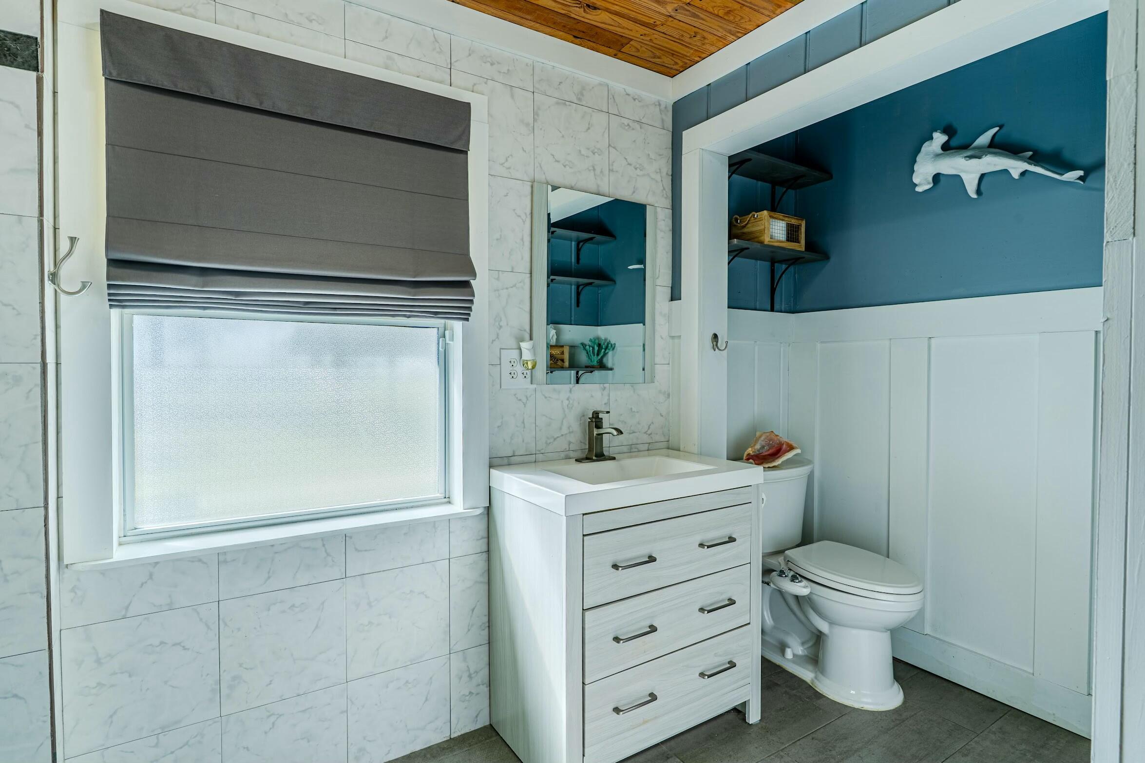 175 Ruth Road Freeport, FL 32439 - Photo 26 of 69 a bathroom with a toilet a sink and mirror