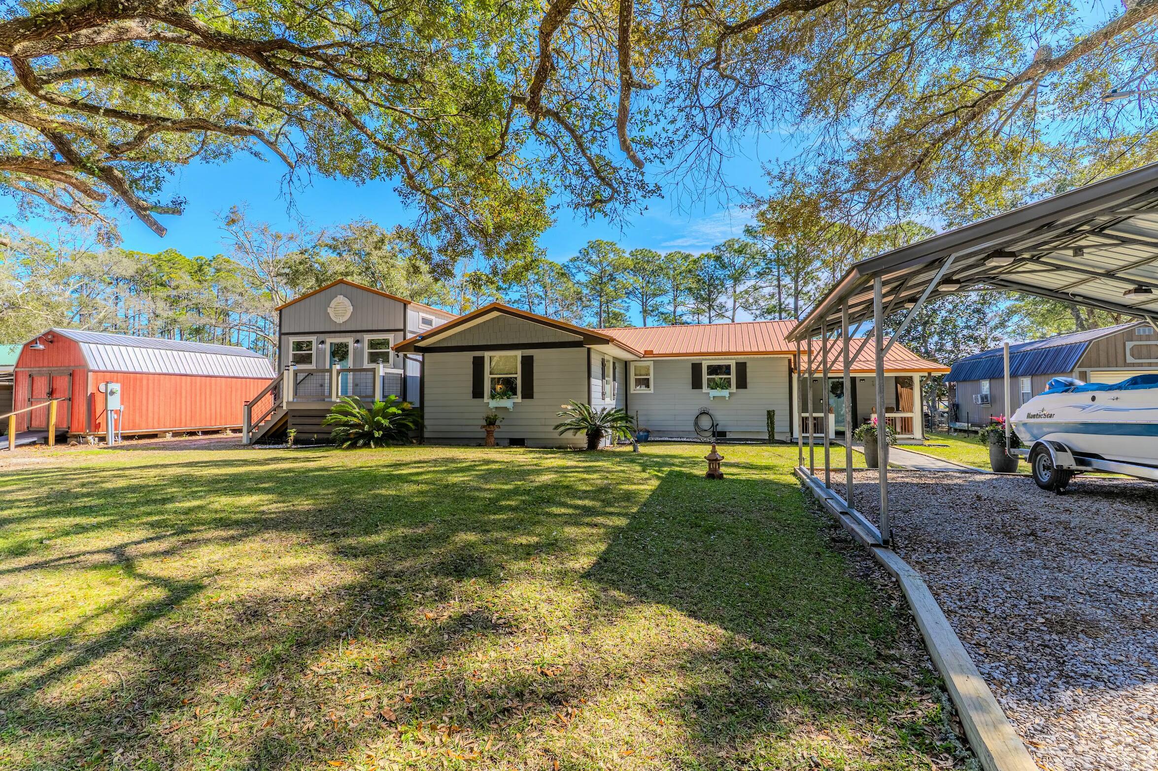 175 Ruth Road Freeport, FL 32439 - Photo 3 of 69 a front view of a house with a garden