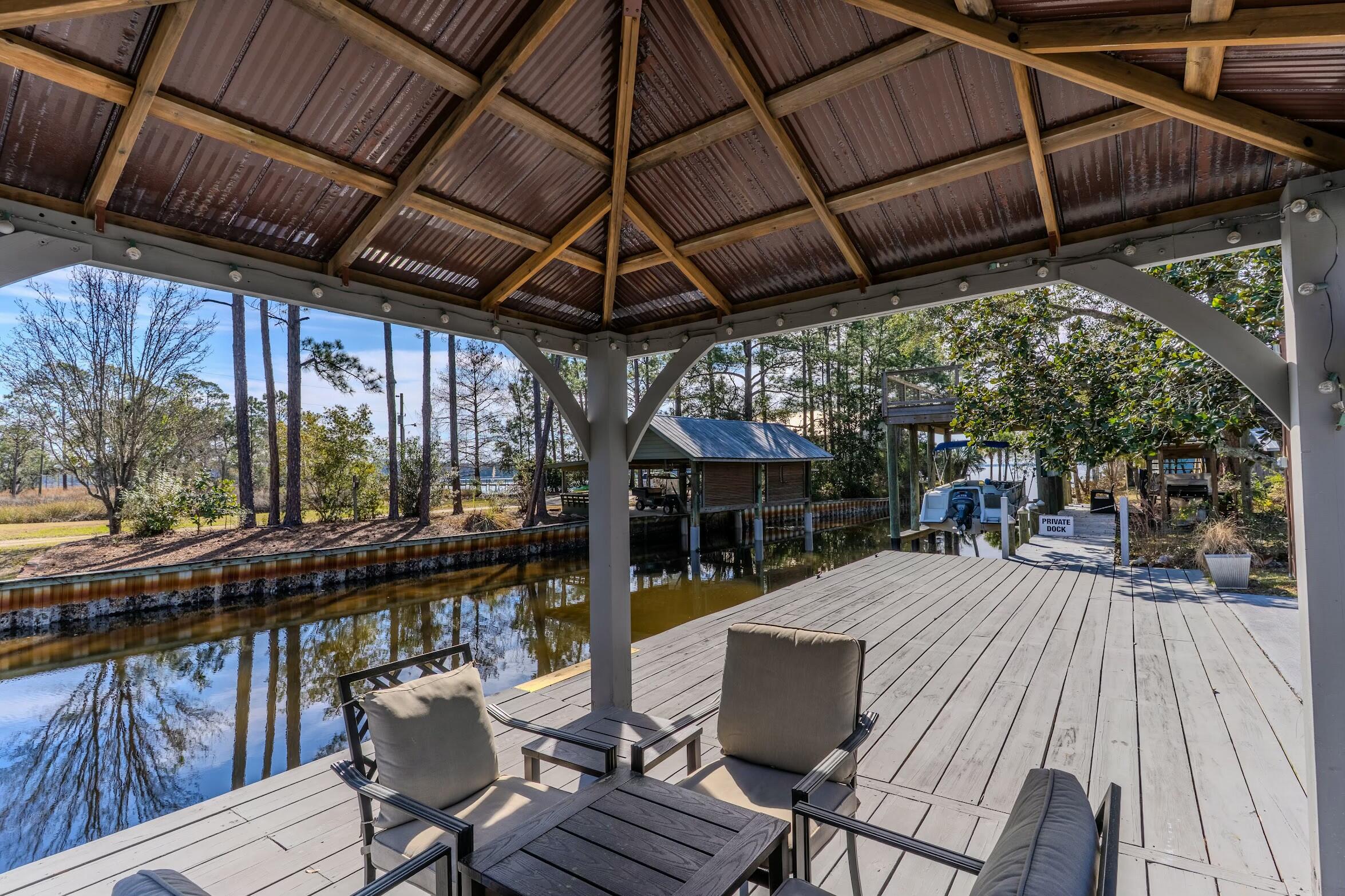 175 Ruth Road Freeport, FL 32439 - Photo 38 of 69 a view of a patio with table and chairs and wooden floor
