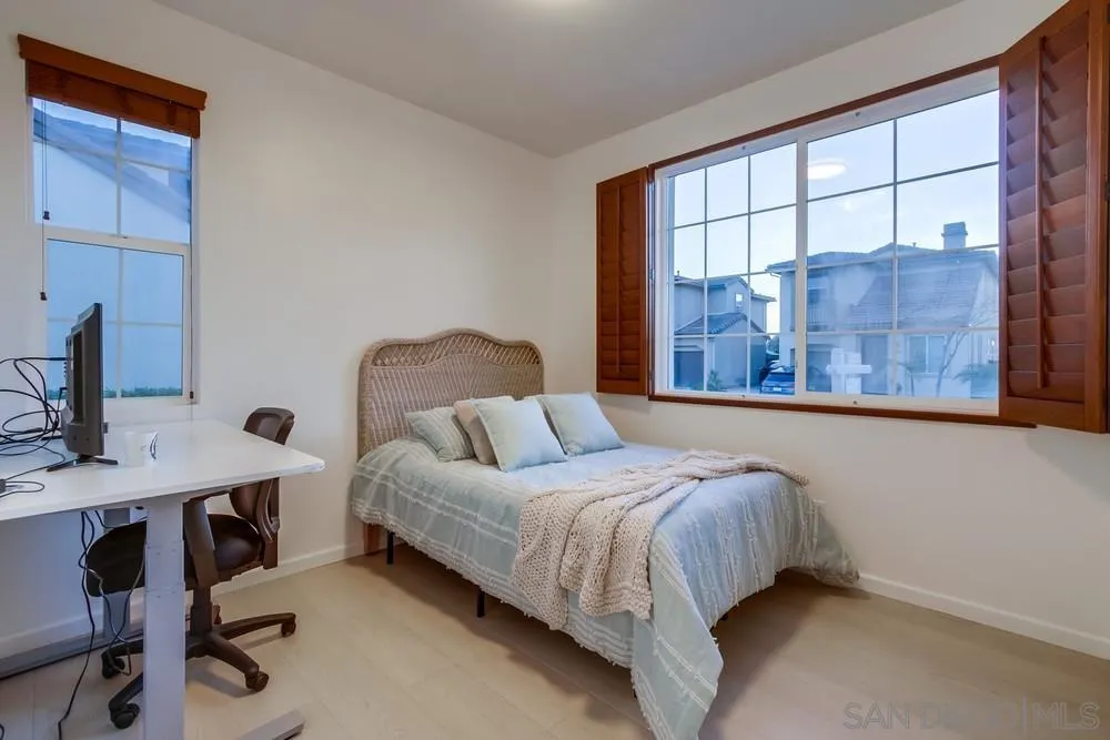 13477 Sydney Rae Place San Diego, CA 92129 - Photo 20 of 73 a bedroom with a bed a desk and chair