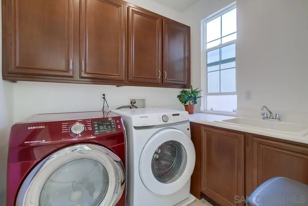 13477 Sydney Rae Place San Diego, CA 92129 - Photo 25 of 73 a utility room with dryer and washer