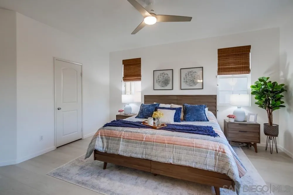 13477 Sydney Rae Place San Diego, CA 92129 - Photo 31 of 73 a bedroom with a bed a table and potted plant
