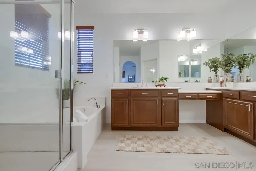 13477 Sydney Rae Place San Diego, CA 92129 - Photo 33 of 73 a bathroom with a sink a vanity and a mirror