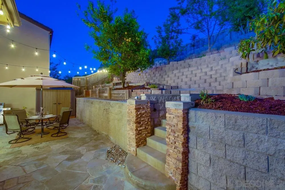 13477 Sydney Rae Place San Diego, CA 92129 - Photo 40 of 73 a view of a patio with table and chairs potted plants