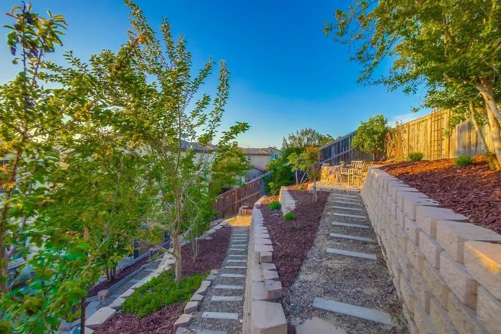 13477 Sydney Rae Place San Diego, CA 92129 - Photo 41 of 73 a view of a yard with wooden fence