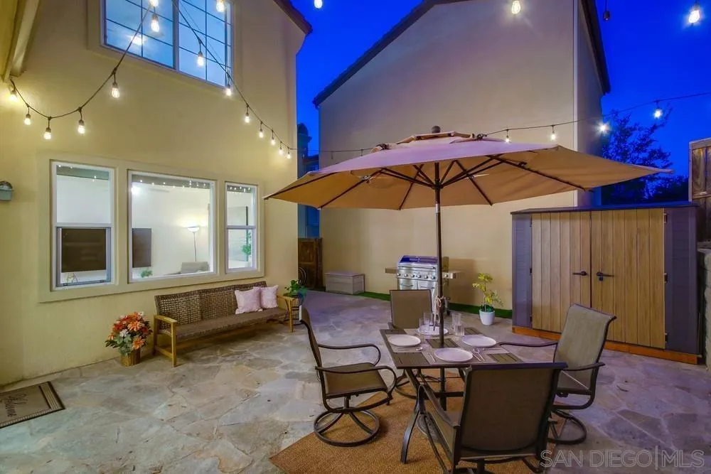 13477 Sydney Rae Place San Diego, CA 92129 - Photo 42 of 73 a view of a dining room with furniture and chandelier