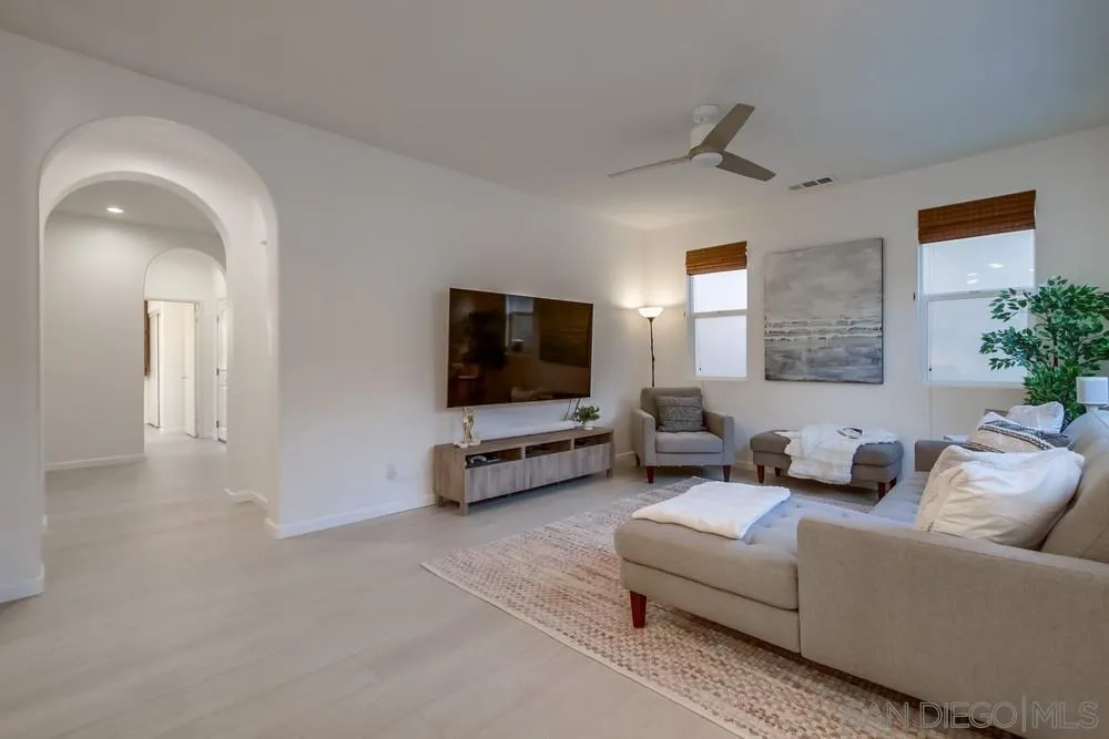 13477 Sydney Rae Place San Diego, CA 92129 - Photo 5 of 73 a living room with furniture and a flat screen tv