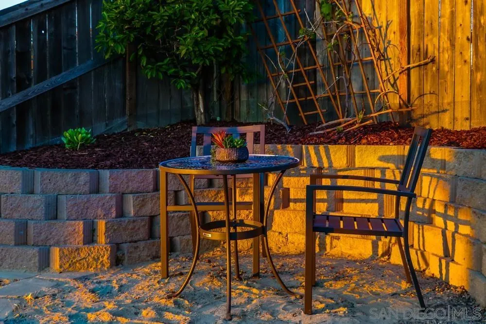 13477 Sydney Rae Place San Diego, CA 92129 - Photo 54 of 73 a patio with table and chairs and potted plants