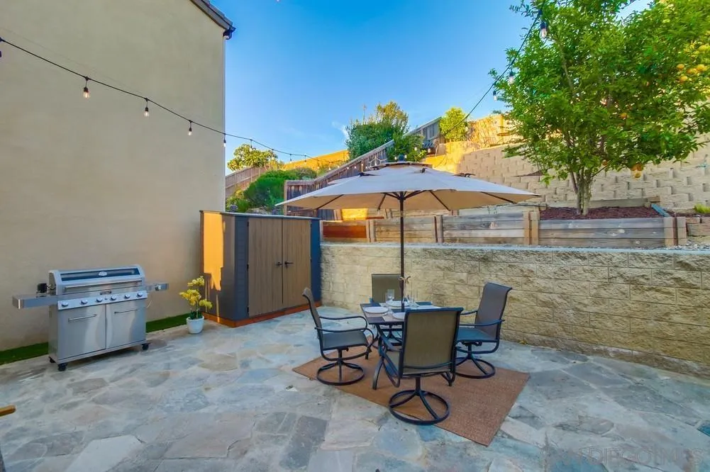 13477 Sydney Rae Place San Diego, CA 92129 - Photo 57 of 73 a view of backyard with seating space and wooden fence