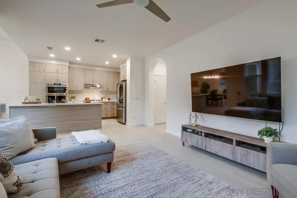 13477 Sydney Rae Place San Diego, CA 92129 - Photo 6 of 73 a living room with furniture and a flat screen tv