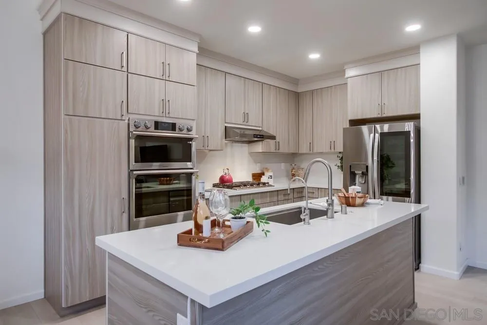 13477 Sydney Rae Place San Diego, CA 92129 - Photo 10 of 73 a kitchen with stainless steel appliances a sink a stove and refrigerator