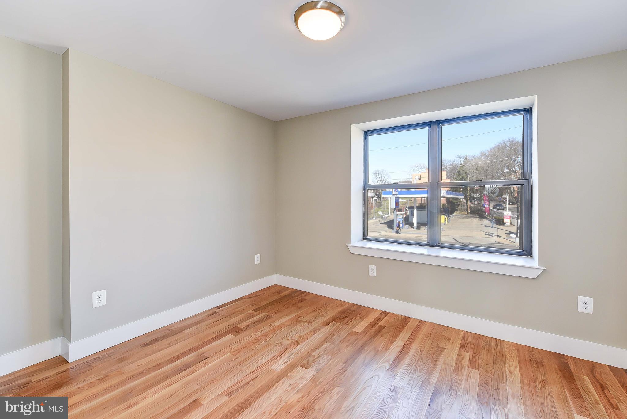 2031 Benning Road Northeast, Unit B Washington, DC 20002 - Photo 7 of 22 a view of a big room with wooden floor and windows