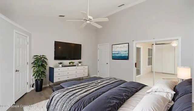 a bedroom with a bed and a flat screen tv