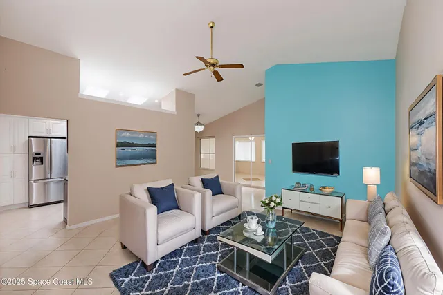 a living room with furniture a rug and a flat screen tv