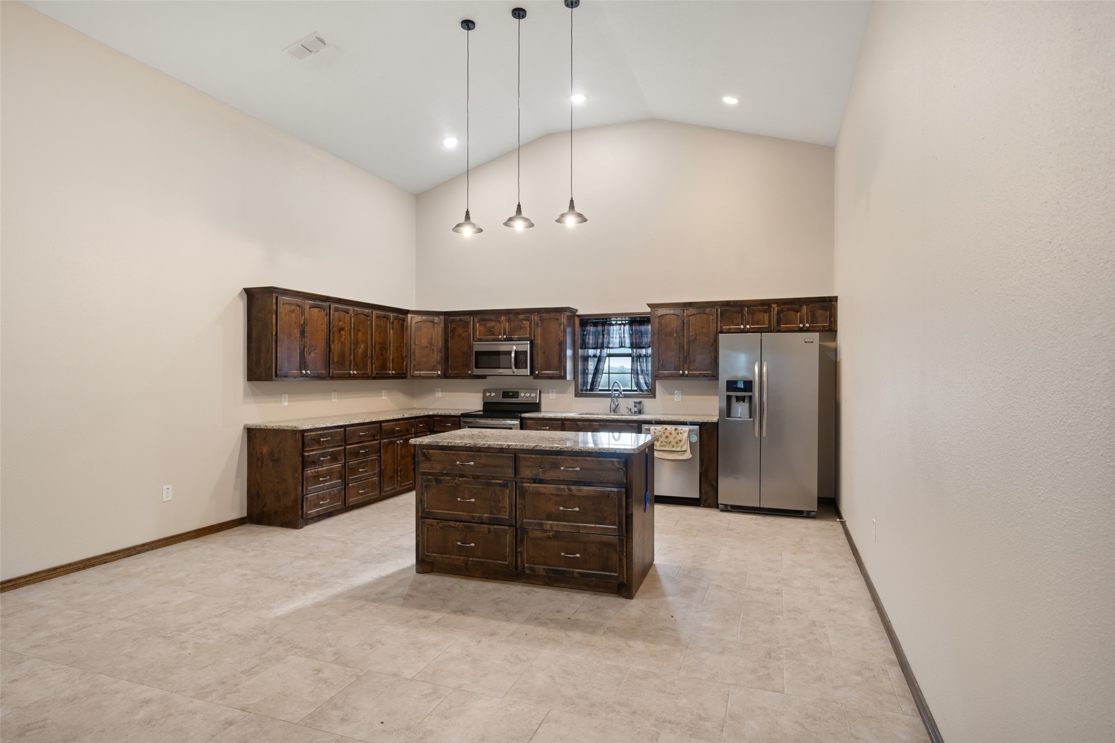 119 Fm 1891 Shiner, TX 77984 - Photo 27 of 40 a kitchen with stainless steel appliances granite countertop a sink a stove and a refrigerator