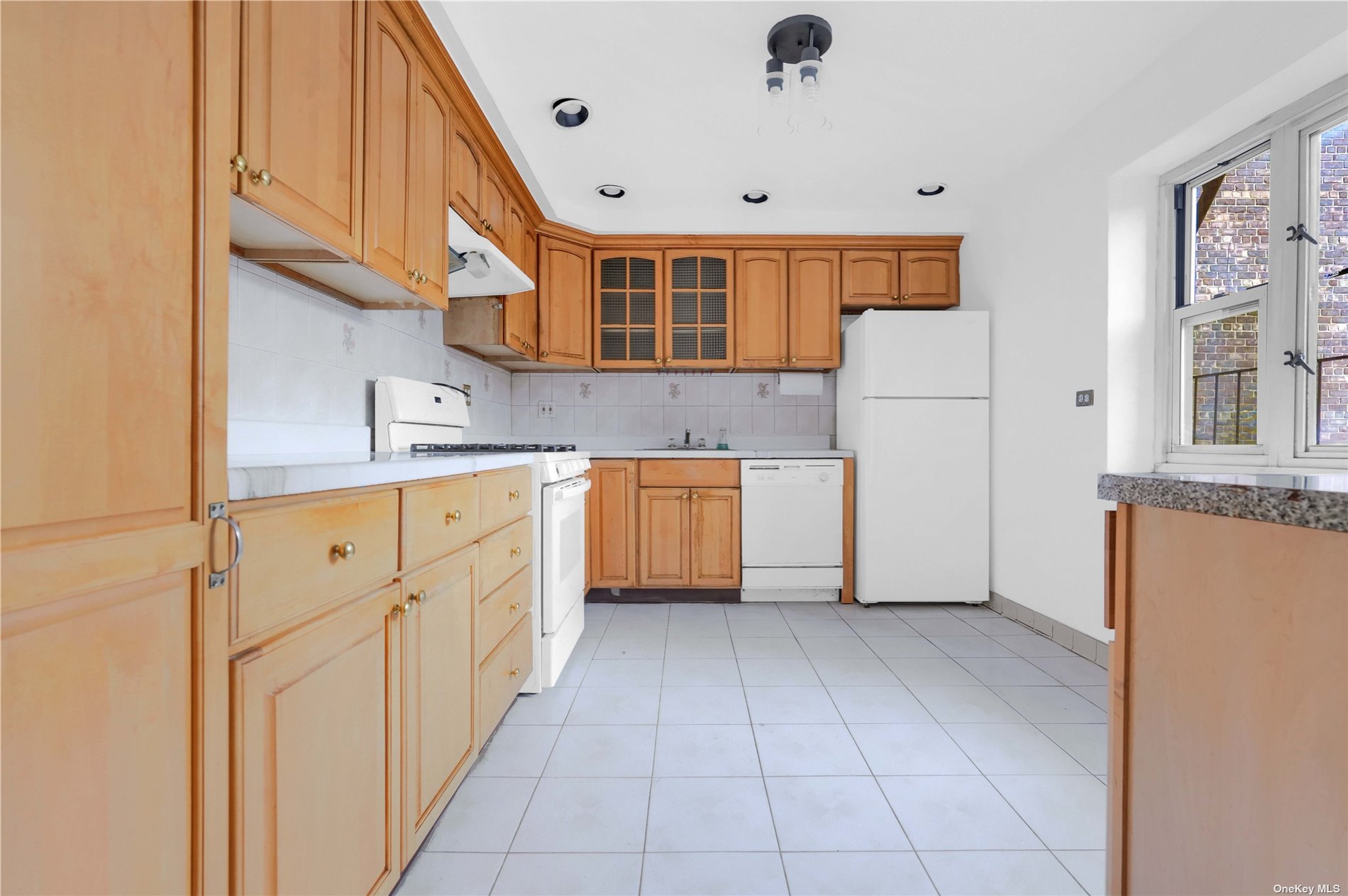 a kitchen with cabinets and a refrigerator