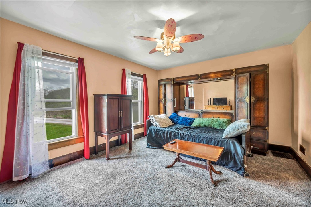 6873 Nichols Road Windham, OH 44288 - Photo 17 of 33 Carpeted bedroom featuring baseboards and ceiling fan