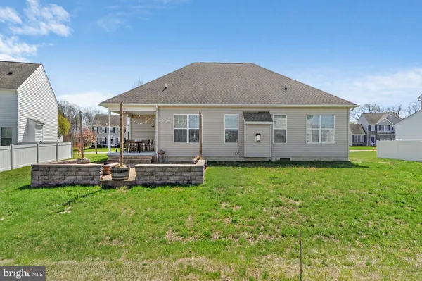 a view of a house with a yard and sitting area