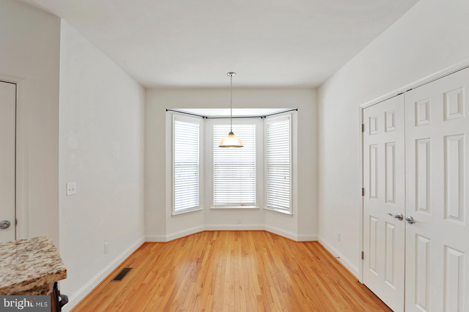 609 Olde Field Drive Magnolia, DE 19962 - Photo 7 of 14 wooden floor in an empty room with a window