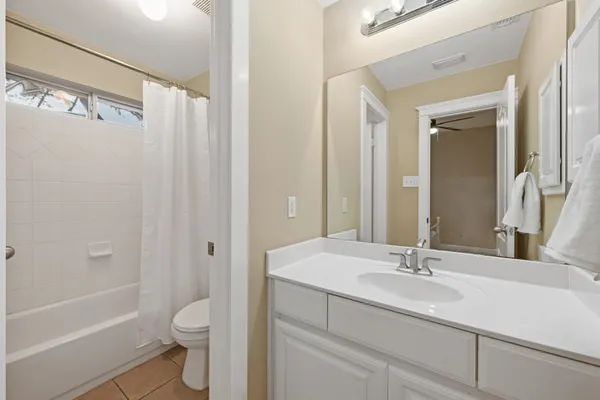 a bathroom with a sink toilet a shower and a mirror