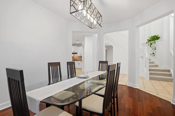 a view of a dining room with furniture wooden floor and chandelier