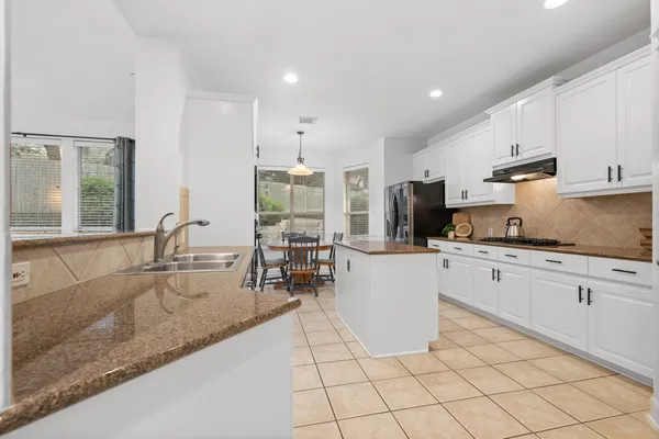 a kitchen with a sink window and cabinets