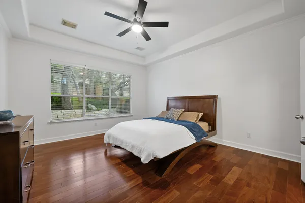 a bed sitting in a bedroom next to a window