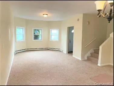 a view of a livingroom with a kitchen