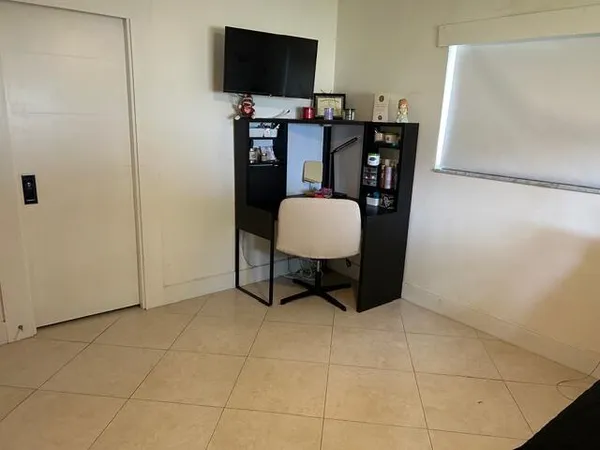 a bedroom with bed and gym equipment