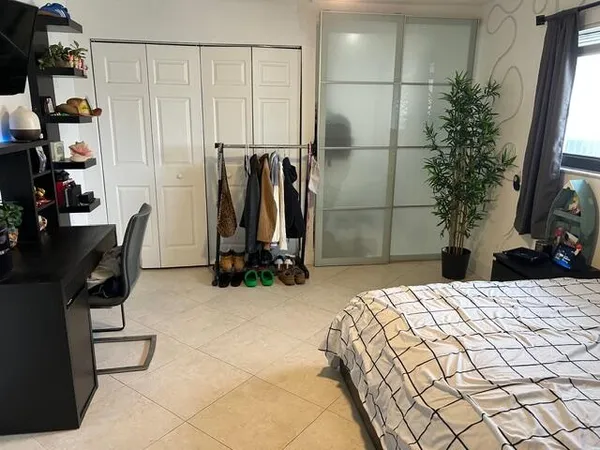a bedroom with a bed and a flat screen tv