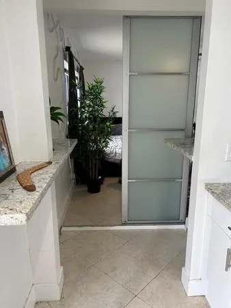 a bedroom with a bed and painting on the wall