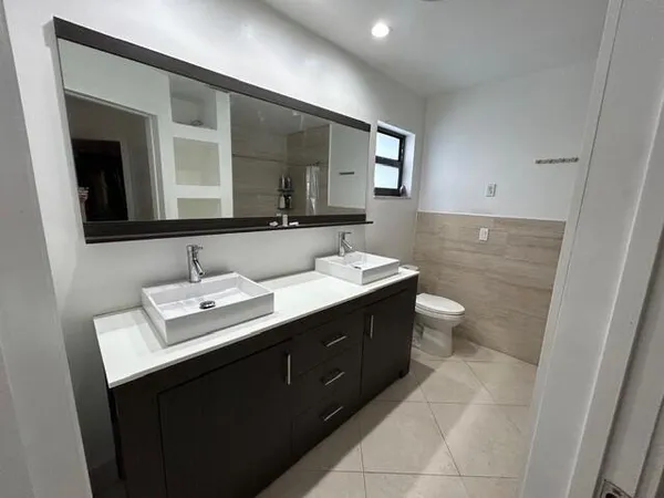 a bathroom with a sink double vanity and a mirror