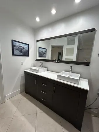 a bathroom with a shower and a glass door