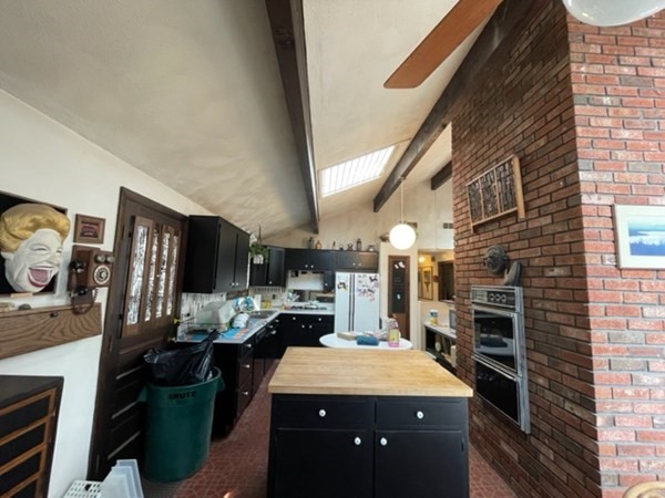 6 Beaver Place Billerica, MA 01821 - Photo 12 of 25 a kitchen with stainless steel appliances kitchen island granite countertop a stove refrigerator and cabinets