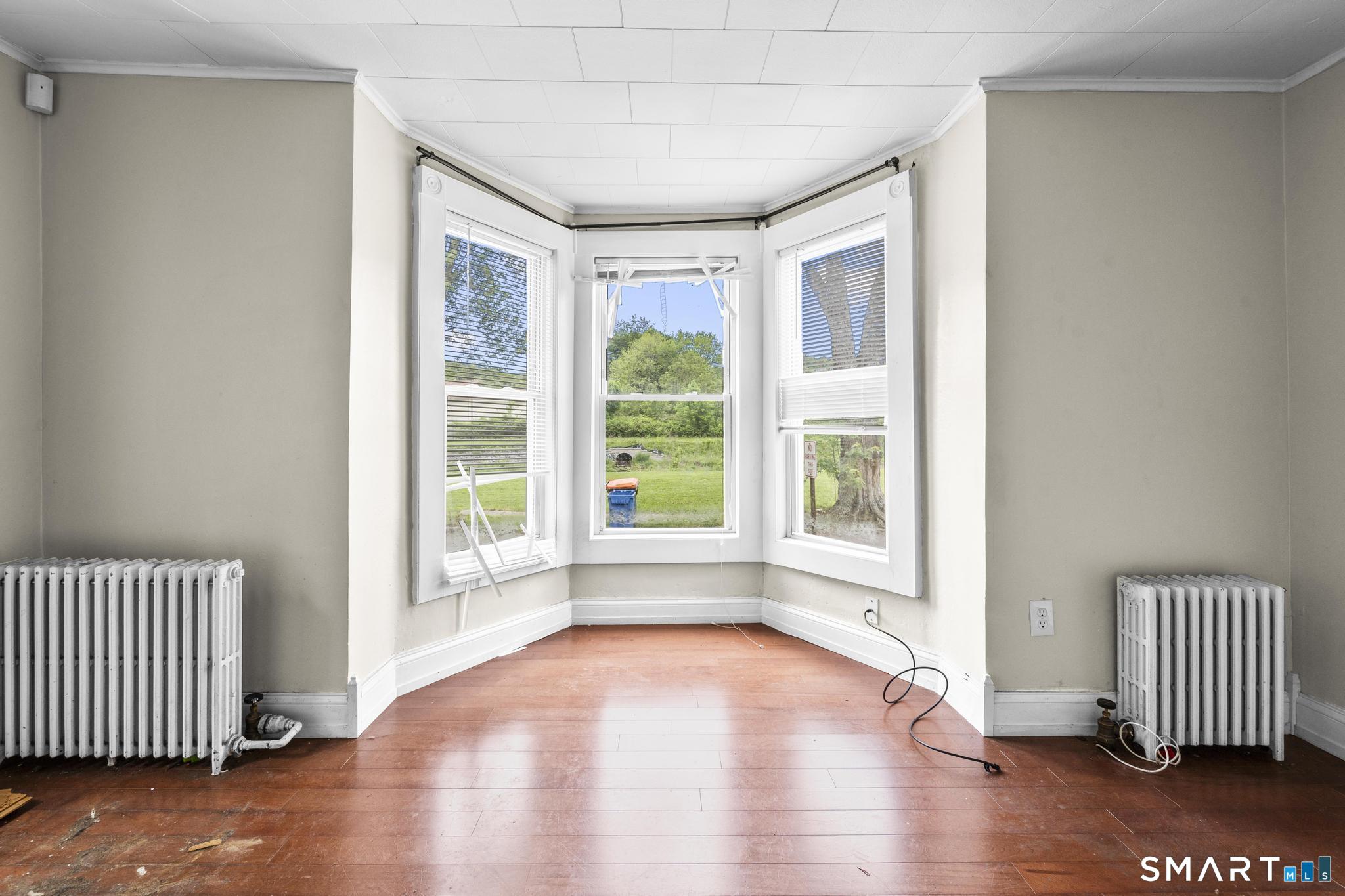 101 Meridian Street Meriden, CT 06451 - Photo 11 of 26 a view of empty room with wooden floor and fan