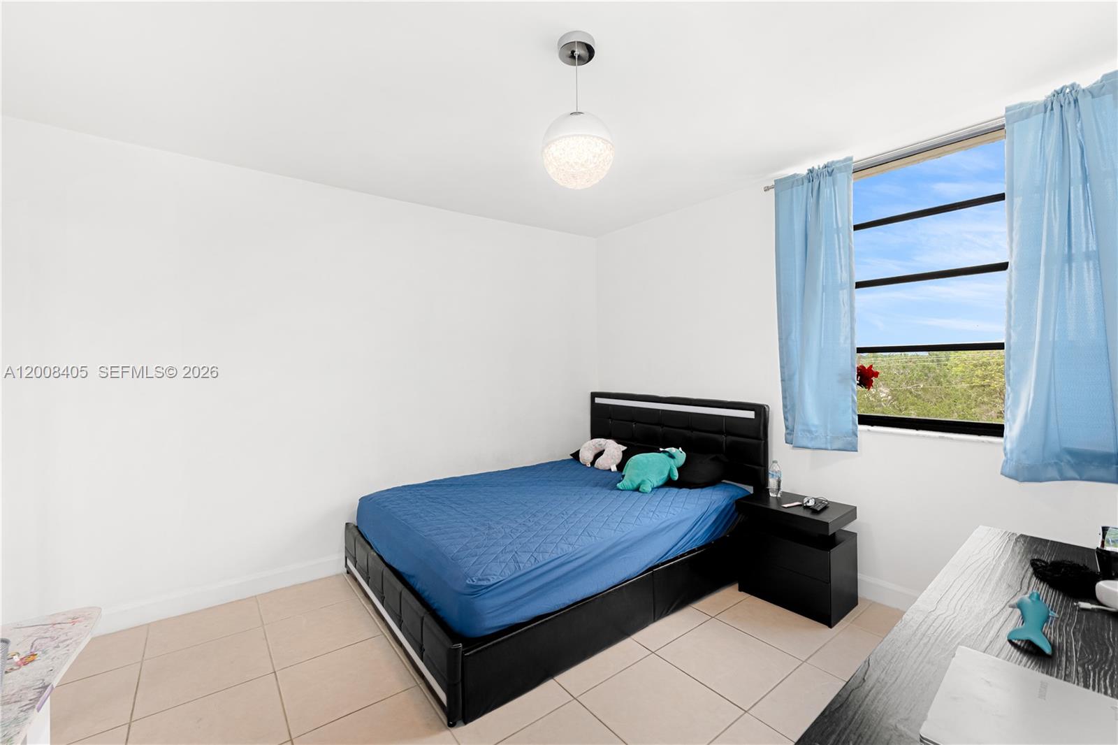 6195 Rock Island Road, Unit 503 Tamarac, FL 33319 - Photo 13 of 29 a bedroom with a bed and a wall painting