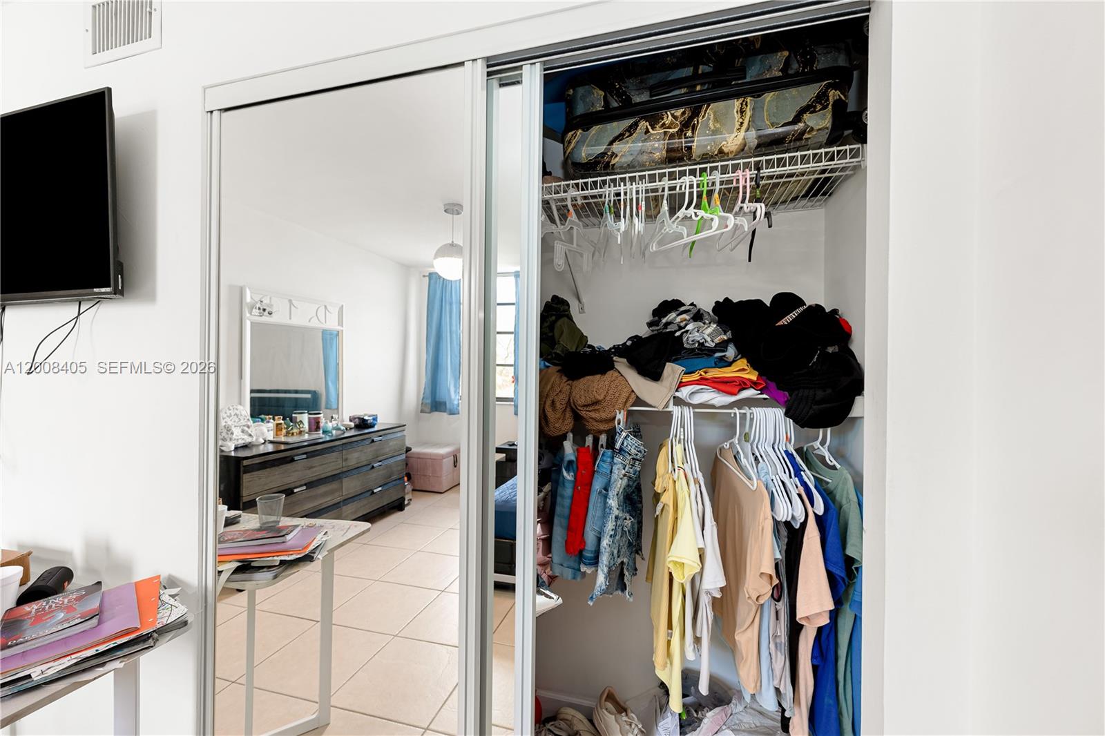 6195 Rock Island Road, Unit 503 Tamarac, FL 33319 - Photo 14 of 29 a view of walk in closet with clothes and shoes